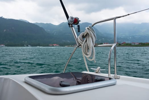 Fishing rod and reel on a sailing yacht. Horizontal shot