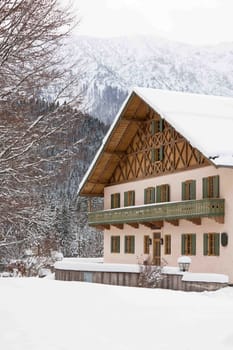 Bavarian style house in snow winter. vertical shot