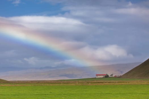 South Icelandic landscape with a house and rainbow
