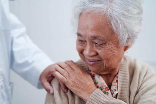 Asian doctor touching patient to support, consolation encourage and help support health care medical.