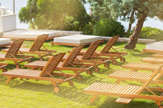 Hotel Poolside Chairs on a green meadow. Horizontal shot