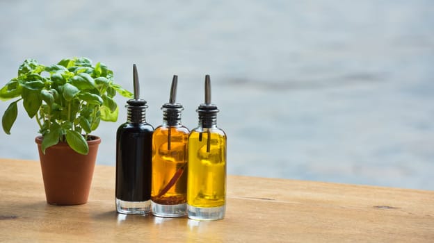 Balsamic vinegar and oil bottles and condiments on the table in an outdoor cafe