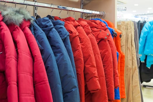 Bright winter clothes hanging at a fashion store