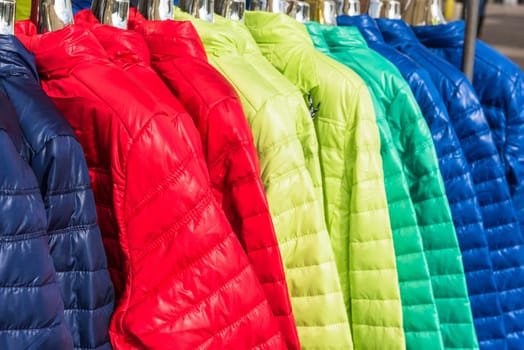 Bright winter clothes hanging at a fashion store