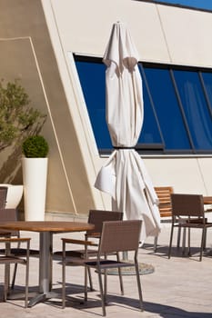 Summer outdoor cafe is empty in a hot midday