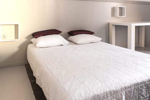 Prepared fresh bed, scene in apartments room. Horizontal shot