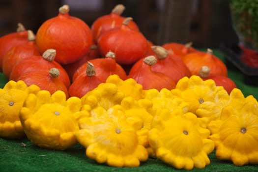 Orange and yellow pumpkins in a market. Horizontal shot with selective focus
