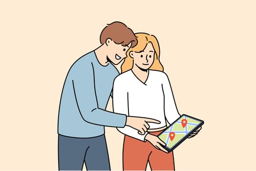 Digital maps are used by man and woman to plot route while traveling to new city. Happy couple holding electronic tablet with street map for navigation and geotags of must-see places