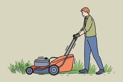 Man uses gas-powered lawnmower to maintain grass in backyard or public park. Gardener guy with lawnmower using garden equipment bought in store and allowing him to simplify process of cutting grass.