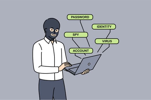 Man hacker hacks website through laptop, standing in mask hiding face to remain anonymous. Anonymous hacker creates spy virus to crack account passwords and steal bank card numbers