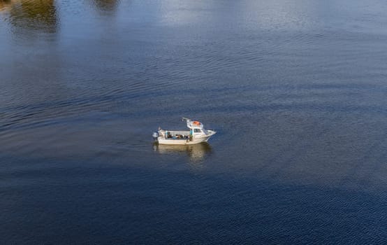 Lisbon, Portugal: February 16, 2024: Fisherman fishing in tagus river near Lisbon, Portugal