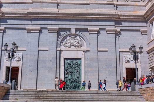 Madrid, Spain: April 24, 2024: People at the entrance of the Almudena Cathedral, Santa Maria la Real de La Almudena.