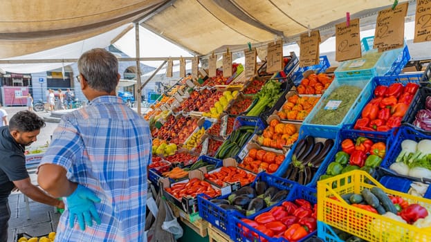 Padova, Italy - July 7 2024. Vegetable market on the Erbe square (Piazza Delle Erbe) in Padova.