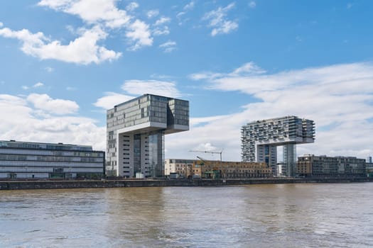 modern residential buildings, crane houses, Kranhaus in the Rheinauhafen in Cologne, seen from the water