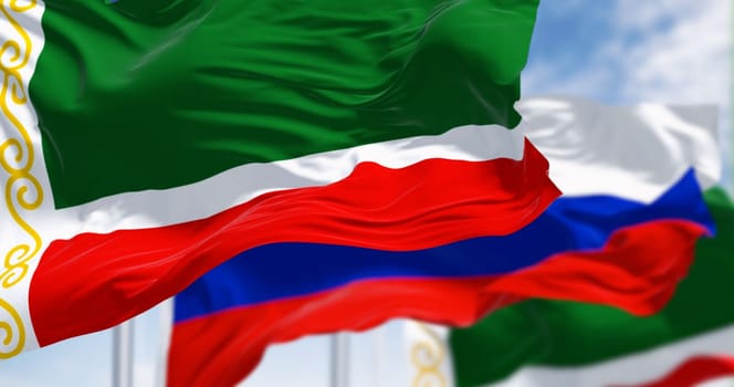 Flags of Chechnya and Russia waving in the wind on a clear day. Russian federal republic. 3d illustration render. Selective focus