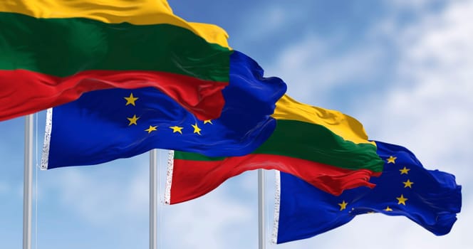 Flags of Lithuania and the European Union waving together on a clear day. Lithuania became a member of the European Union on 2004. 3D illustration render. Rippled fabric. Selective focus