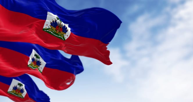 Haiti national flags waving on a clear day. Two horizontal bands of blue and red with national coat of arms in a small white rectangle in the center. 3d illustration render. Rippling fabric