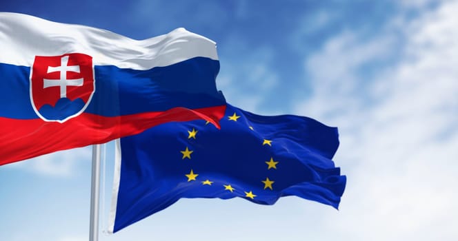 Close-up of Slovakia and the European Union flags waving in the wind on a clear day. 3d illustration render. Fluttering fabric. Selective focus