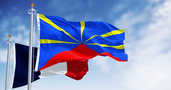 Reunion and national french flags waving on a clear day. Island in the Indian Ocean and overseas department and region of France. 3d illustration render. Selective focus