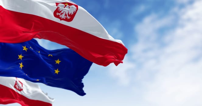 Close-up of Poland national flag waving in the wind on a clear day. Two horizontal white and red stripes with coat of arms. 3d illustration render. Rippling fabric. Selective focus
