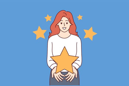 Feedback from woman showing large star, symbolizing high rating for quality product. Girl member of jury gives rating to speaker at television competition of talented people fighting for money