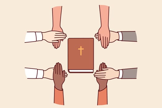 Hands of christians believers held bible, which allows them to commune with lord and learn prayers or gospel. Christians feel unity and cohesion through common faith and opportunity to go to church