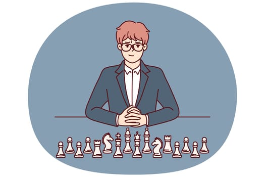 Businessman with chess pieces sits at table and looks at screen for concept of strategic planning in business. Man ceo of large corporation near chess symbolizing mind and strategic thinking