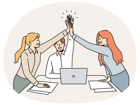 Successful business team rejoicing at completion of project, standing near office desk and giving high five to colleagues. Young successful paperwork clerks celebrating good performance