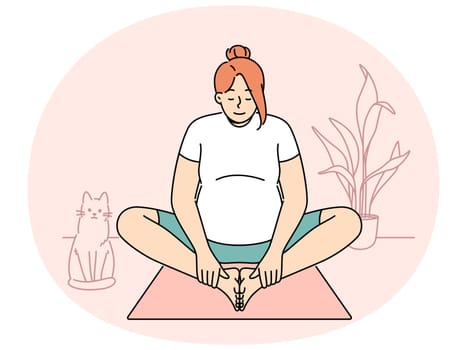 Pregnant woman making morning exercises sitting on fitness mats and getting ready for meditative practices from yoga. Pregnant girl is at home and stretches doing yoga for expectant mothers