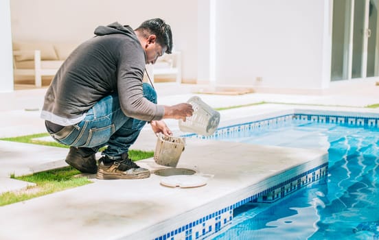 Person cleaning garbage filter basket for swimming pool. Man cleaning swimming pool filter basket