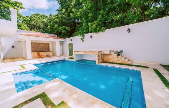 Domestic swimming pool designs. Homemade swimming pool surrounded by nature trees