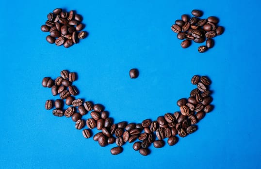 Funny smile from roasted coffee beans. Roasted coffee beans forming a smile isolated