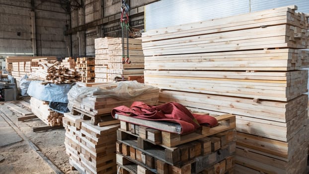 Stacked wooden planks close-up at lumber warehouse. Wood industry concept