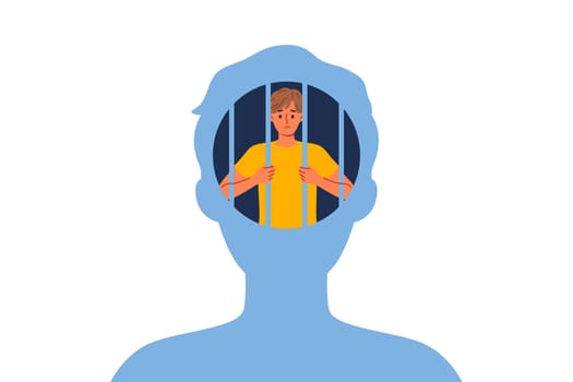 Man hostage to own psychological trauma, sits in prison inside head and needs psychotherapist. Guy with psychological trauma experiences stress and melancholy due to unwillingness to fight for success