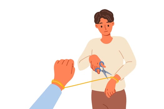Man breaking up with woman and cuts rope on hand, due to lack of love after betrayal. Breaking up with girlfriend after toxic relationship that negatively affects psychological health