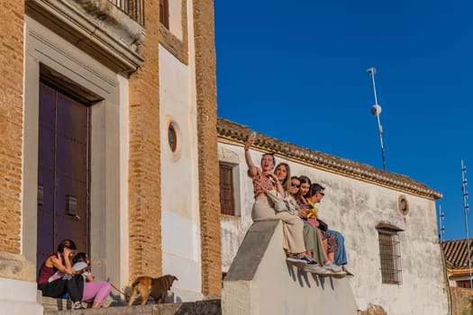 Granada, Spain: April 15, 2024: Young people at the Ermita de San Miguel el Alto waiting for the sunset in Granada. Andalusia, Spain