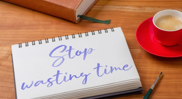 Notepad on a desk - Stop wasting time