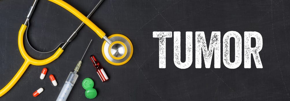 Stethoscope and pharmaceuticals on a blackboard - Tumor