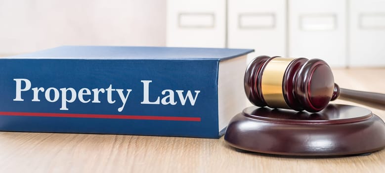 A law book with a gavel  - Property Law