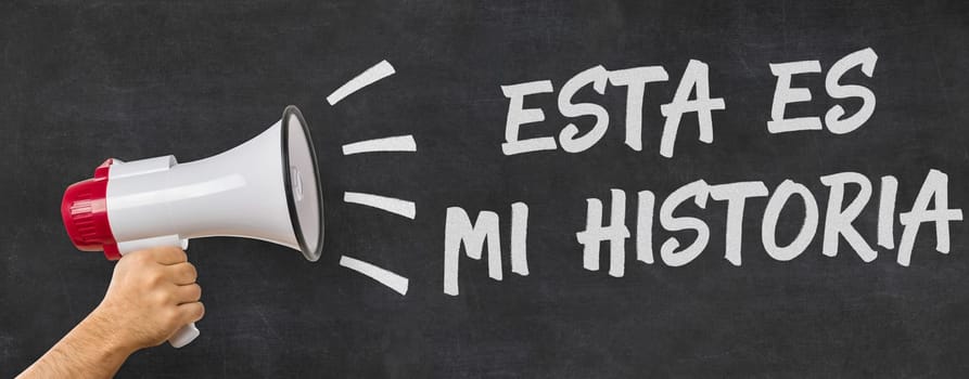 A man holding a megaphone - That is my story in spanish