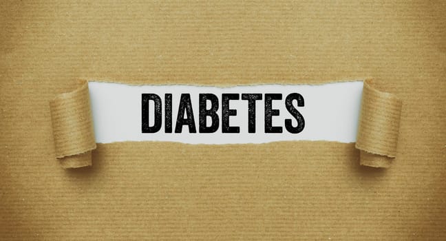 Torn paper revealing the word Diabetes