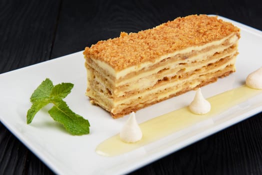 Esterhazy traditional cake on a white plate with mint