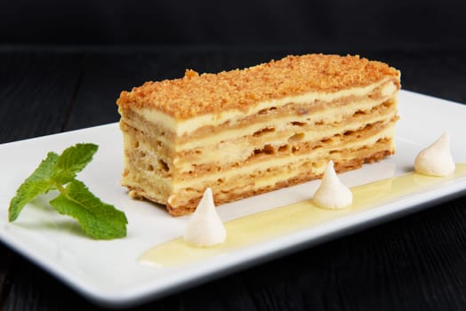 Esterhazy traditional cake on a white plate with mint