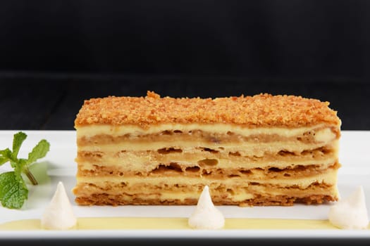 Esterhazy traditional cake on a white plate with mint