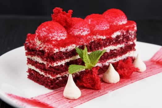 Plate with piece of delicious red velvet cake on white background