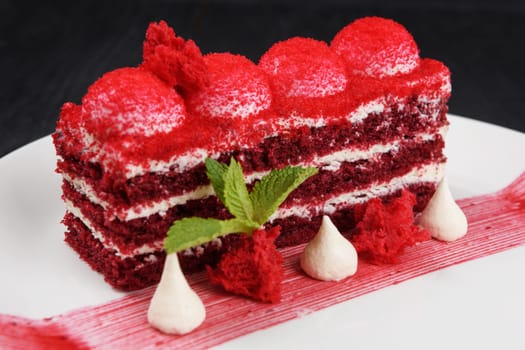 Plate with piece of delicious red velvet cake on white background