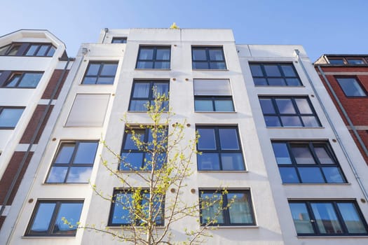 Modern white residential building in spring from the frog's perspective, Bremen, Germany