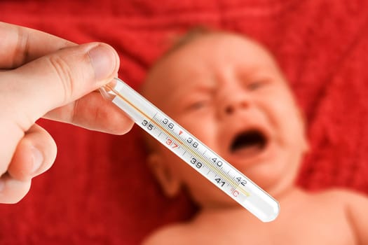 hand check the temperature of ill baby