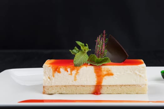 Cheesecake with sauce, caramel chocolate and mint