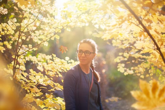 Woman autumn portrait in warm sunny october day with natural light.